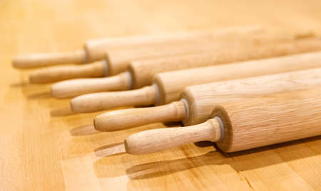 wooden rolling rollers to roll out the dough lie in a row on a wooden table. selective focus.High quality photoの写真素材