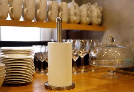 Clean utensils stand in rows in cafes after washing and paper towels in a roll. selective focus. High quality photoの写真素材