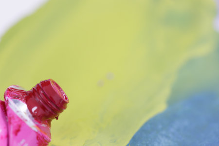 used tube of red paint for drawing crumpled and stained. selective focusの写真素材
