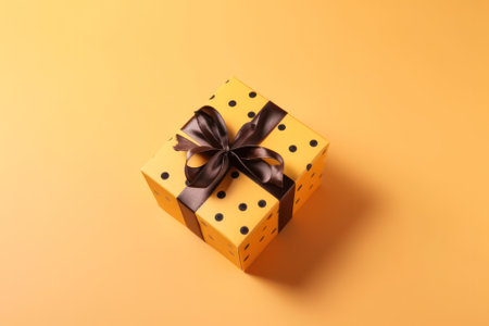 gift box tied with a silk ribbon on a yellow background postcard .Free space for your text.Generative AIの素材