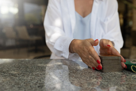 Young woman holding tarot cards. Concept of fortune telling, predictions, oracle and love magic on tarot cards.lifestyle or spirituality contentの写真素材