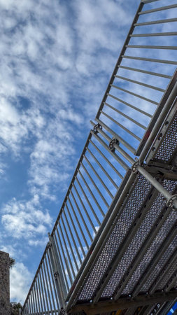 Metal Staircase Railing with Cloudy Sky Backdrop. High quality photoの写真素材