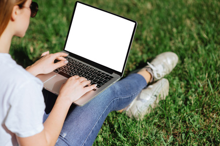 The girl works on a laptop.の写真素材