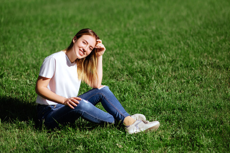 pretty young woman in a park.の写真素材