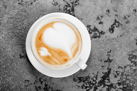 Top view of hot coffee cappuccino on gray table backgroundの写真素材
