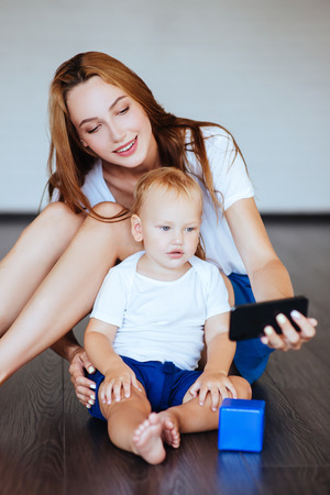 Happy mother with son and smartphoneの写真素材
