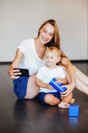 Happy mother with son and smartphoneの写真素材
