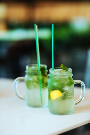Lemonade from lime with mint, mohito, with ice, glass jar, mason jar.の写真素材