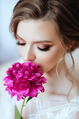 Beautiful model girl with flowers peonyの写真素材