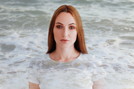 Double exposure of girl profile portrait and sea