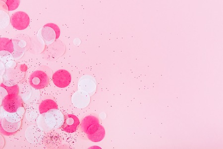 Flatlay of Colorful Round Paper Confetti on pink Paper. Top viewの写真素材