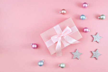 Gift or present box on pink table top view. Flat lay composition for Christmas or new year.の写真素材