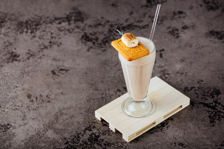 Glass of vanilla milkshake with whipped creamの写真素材