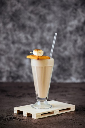 Glass of vanilla milkshake with whipped creamの写真素材
