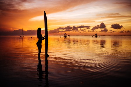 Beautiful woman in a diving suit for swimming surfing in the Indian Ocean
