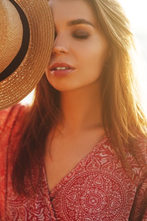 woman feeling free meeting sun near the seaの写真素材