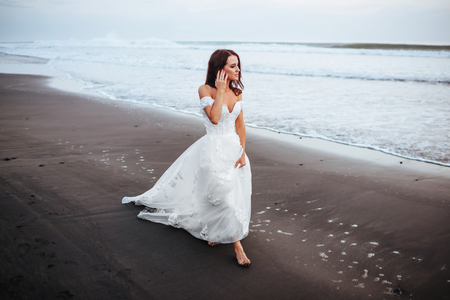 Bride on a beach in the blue waterの写真素材