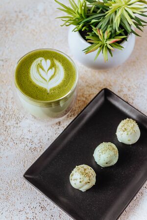 hot mocha green tea latte with candiesの写真素材