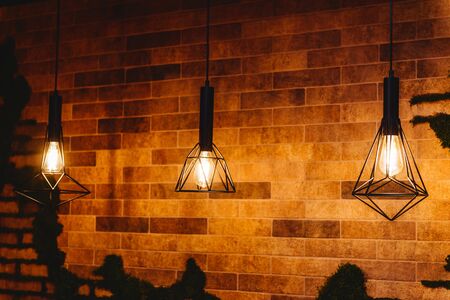 Close up many yellow lamp in cafe at night for backgroundの写真素材