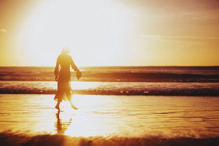 Woman Enjoying Beautiful Sunset on the Beach