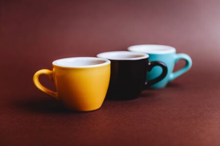 Threee colorfull cups of espresso coffee on dark backgroundの写真素材