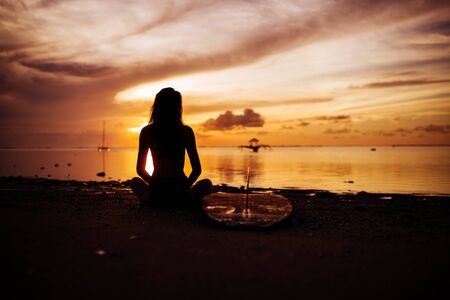 Surf girl with surfboard on the beachの写真素材