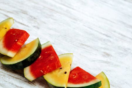 watermelon red and yellow sliced on white backgroundの写真素材