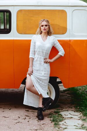 Beautiful lady standing near retro car.の写真素材