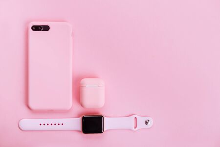 Up to date technology.Top view of diverse personal accessory laying on the pink backgroundの写真素材