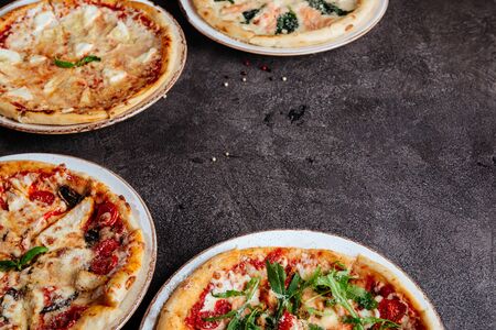 Traditional Italian pizza on a dark background top view copy space.の写真素材
