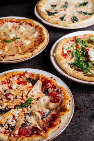 Traditional Italian pizza on a dark background top viewの写真素材