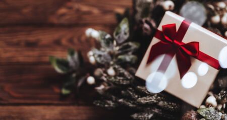 Banner of Christmas presents with red ribbon on dark wooden background in vintage styleの写真素材