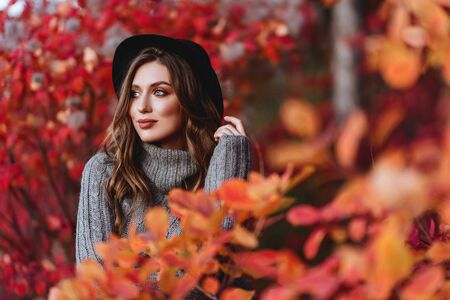 Fashion woman on a background of autumn leaves