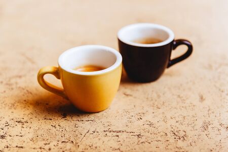 Two color coffee cups on light background copy spaceの写真素材