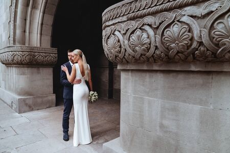 Happy bride and groom near old castleの写真素材