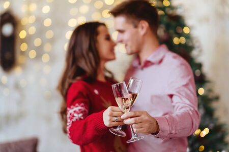 photo of two people holding glasses of shampagne on xmasの写真素材