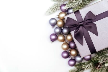 gift box wrapped kraft paper with Christmas decorations, spruce branches and Christmas balls on white background.の写真素材