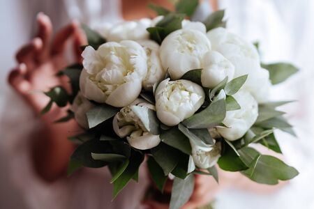 Close-up image of a beautiful and stylish wedding bouquet of white and pink peonies. Summer floral composition.の写真素材