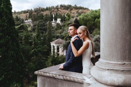 Happy bride and groom near old castleの写真素材