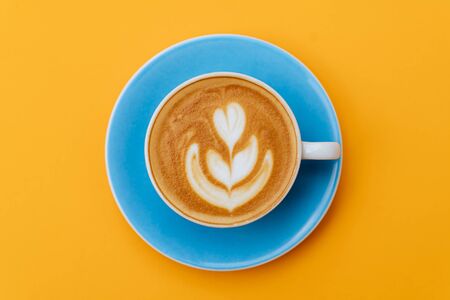 Cup of fresh coffee on blue backgroundの写真素材