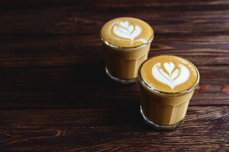 two cups of coffee on vintage wood. Top view , cup on wooden table.の写真素材