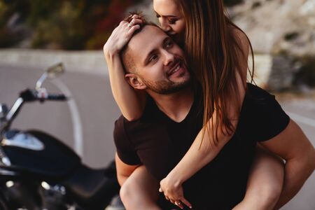Couple of lovers kissing and hugging on motorbike - Two bikers stop in the countryside