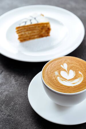 cup of coffee and cake on black stone backgroundの写真素材