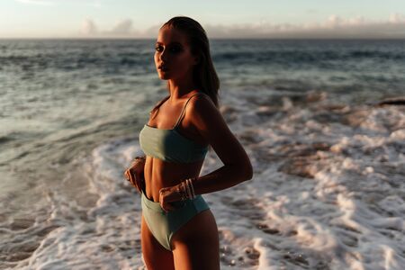 Beautiful and fashion young woman outfit posing at beach.