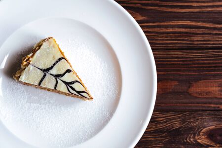 carrot cake with walnuts, prunes and dried apricots on a dark wood background. tinting. selective...