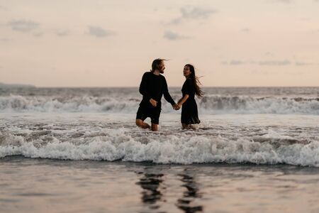 Young couple in love, Attractive man and woman enjoying romantic evening on sunsetの写真素材