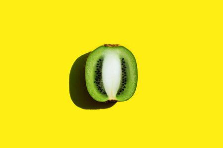 Beautiful slice of fresh juicy kiwi on yellow backgroundの写真素材