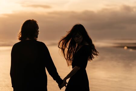 Young couple in love, Attractive man and woman enjoying romantic evening on sunsetの写真素材