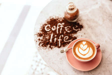 Pink cup of cappuccino on marble table background.の写真素材