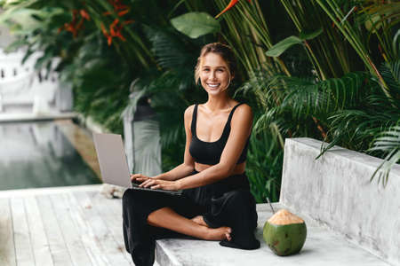 Woman freelance work typing on laptop with fresh coconut .の写真素材